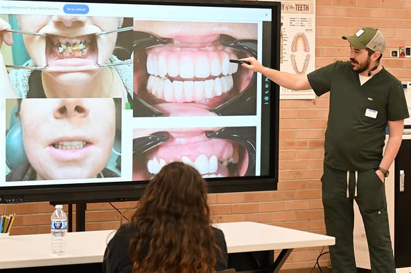 A man in scrubs and a baseball hat shows before and after photos of a dental implant