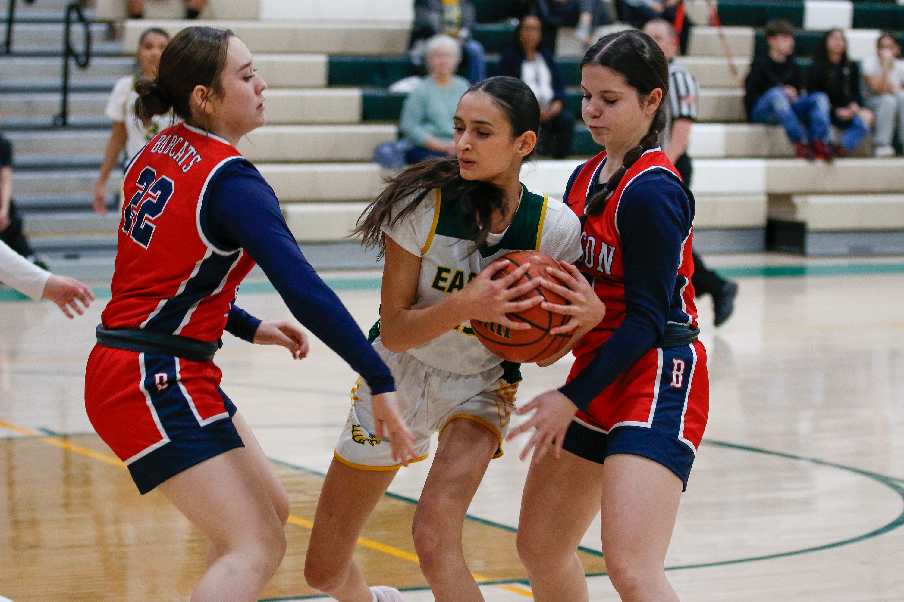 A Santa Rita player keeps the basketball away from two of her opponents