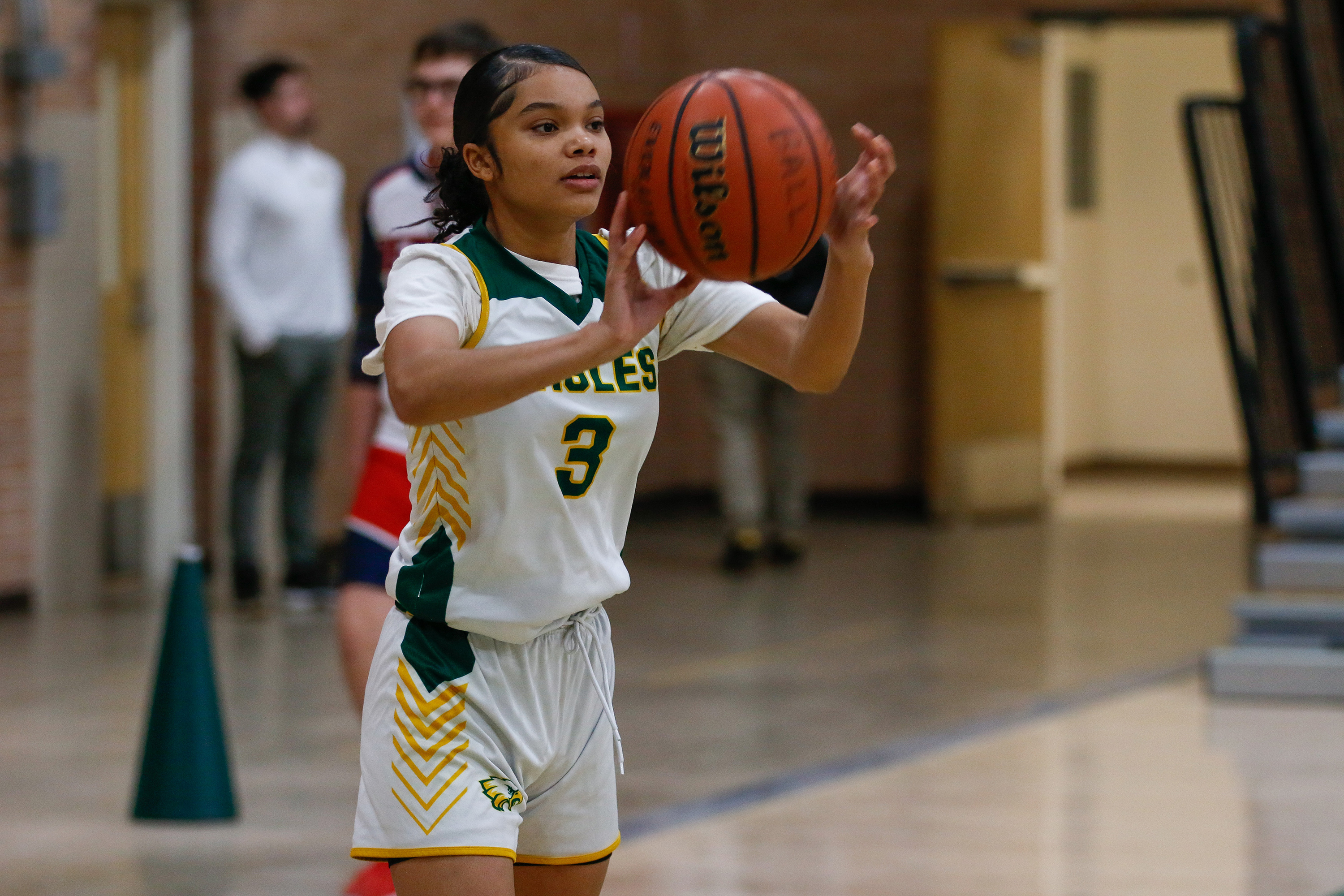 A Santa Rita player holds the basketball in front of her