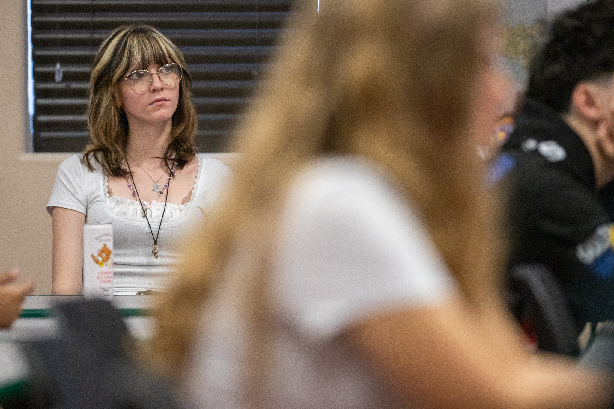 A female student listens intently on the first day of school