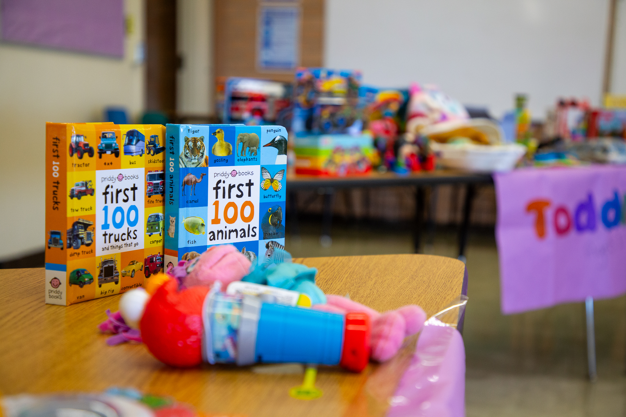 Toys and children's books sit on a table