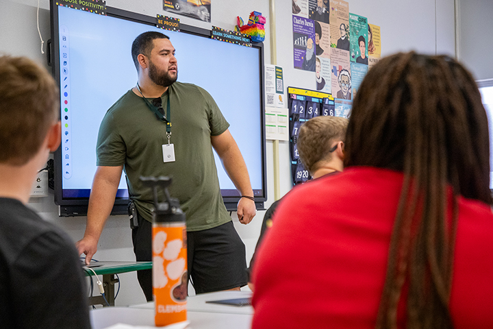 A teacher addresses his class on the first day