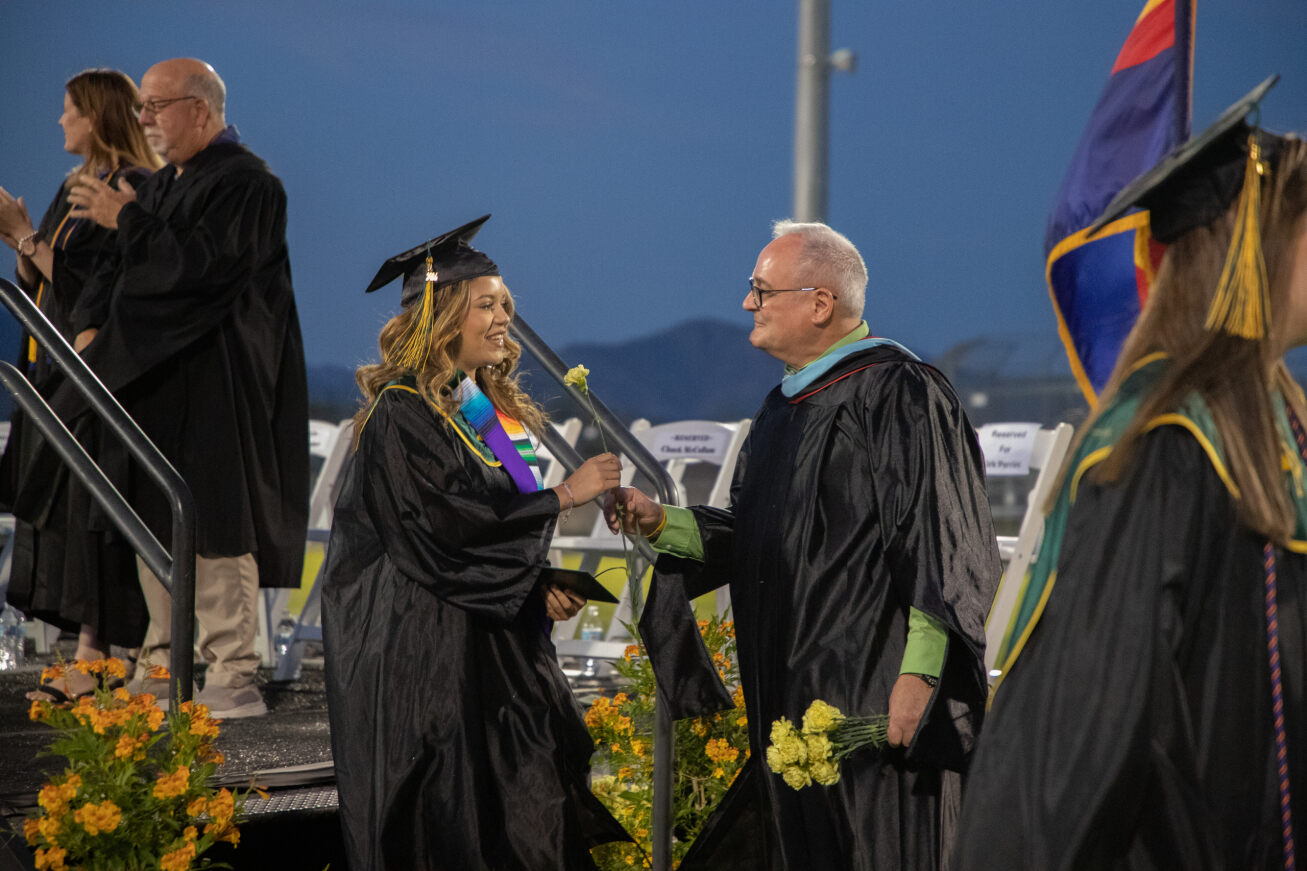 A Santa Rita grad receives her yellow rose as she steps across the stage